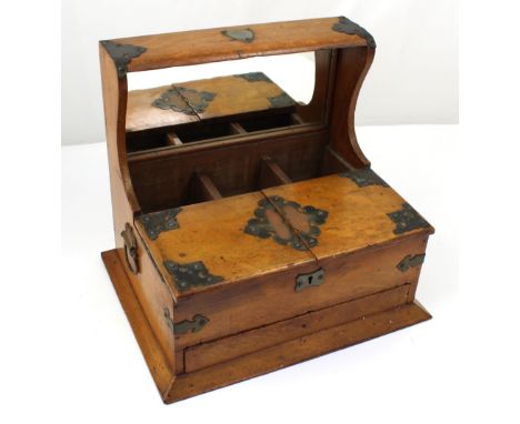 A 19th century oak tantalus cabinet, lacking bottles, with cigarette box front and button release lower drawer, bottle compar