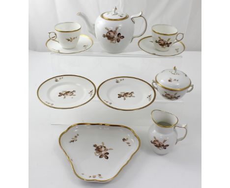 A Royal Copenhagen tête-à-tête tea service, decorated with floral sprays within a gilt edge, each peace marked.