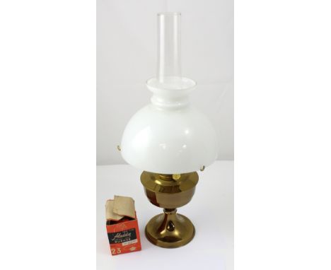 A  mid-to-late 20th century brass paraffin lamp with latte glass shade and smoke stack, height 60cm.