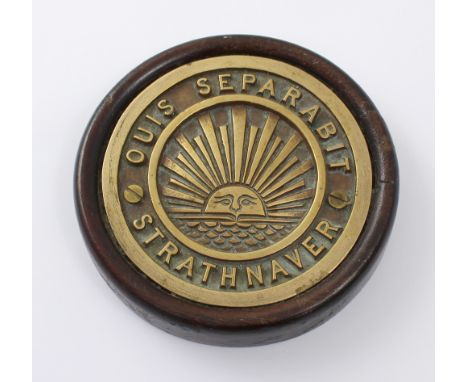 A ships tompion from the SS Strathnaver, cast in bronze and mounted in a wooden bezel, the disc displays a sun rising over th
