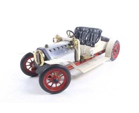 A Mamod live steam model car. In white with red wheels and black seat, complete with burner pan and spare wheel, unboxed. 