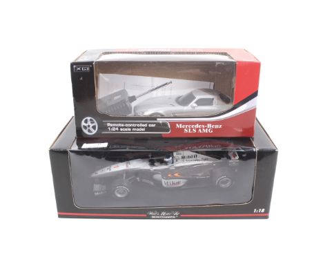 Two scale model cars. One Minichamps 1:18 scale McLaren MP 4/14 racing car and one 1:24 scale Mercedes SLS AMG remote control