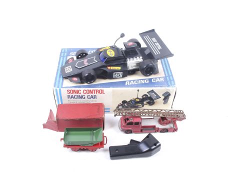 A collection of vintage toys. Including a Dinky fire engine, a sonic control racing car and a Hornby goods wagon. 
