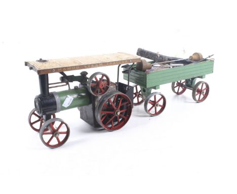 A Mamod live steam traction engine and trailer. Green body with red wheels and white roof, complete with burner pan etc. 