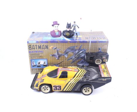 Two battery operated remote control vehicles. Including Batman Batwing, a battery operated remote control car, in original bo
