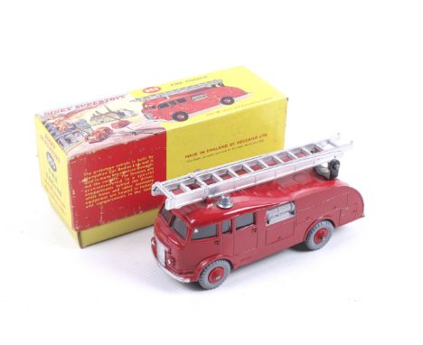A Dinky diecast Fire Engine. No. 955, red body with chrome trim and ladder, in original box.