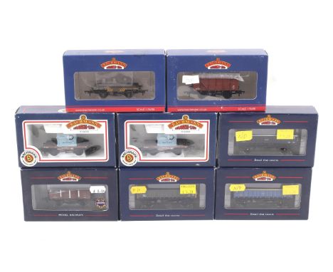 Eight Bachmann OO gauge goods wagons. Including box cars, flatbeds, etc. all in original boxes.