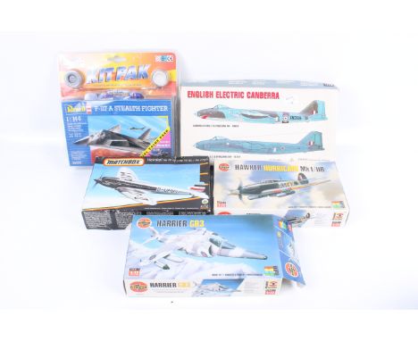 A collection of five model aeroplane kits. Including the Hawker Hurricane and the Harrier GR3, from Airfix and Revell. 