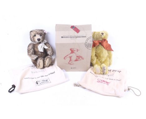 Two Steiff musical teddy bears. Comprising one musical bear with orange neck tie and one with white neck tie, both in working