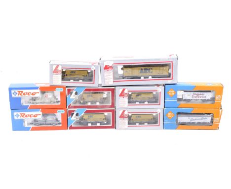 Ten OO gauge goods wagons. Featuring hoppers and box cars etc from Roco and Lima, all in original boxes. 