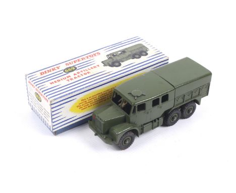 A Dinky diecast Medium Artillery Tractor. No. 689, with green body and black wheels, in original box.
