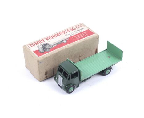 A Dinky diecast Guy Flatbed Truck. No. 513, dark green body with light green bed, in original box.