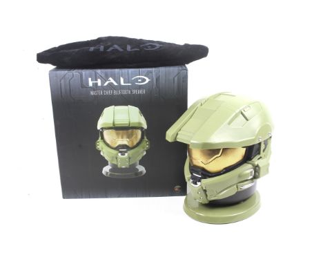 A Halo Master Chief Bluetooth Speaker. In the shape of his helmet, green complete with stand, in original box.
