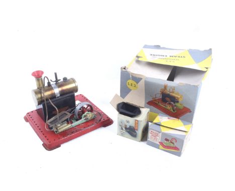 A Mamod SE2 live steam engine. With power hammer and circular saw plus burner pan, in original box.