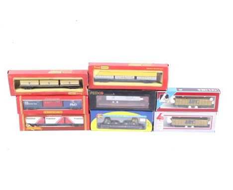 Eight OO gauge goods wagons. Mainly containers and flatbeds from Hornby, Lima and Penco etc, all in original boxes.