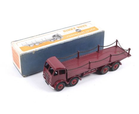 A Dinky diecast Foden Flat Truck. No. 505, red body and wheels with chain, in original box.