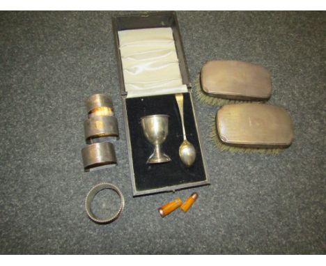 A silver christening egg cup and spoon, marked Birmingham, two silver backed gent's hair brushes, four assorted silver napkin