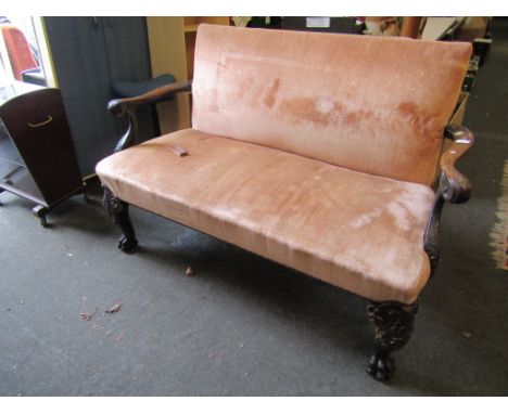 A Victorian two seater sofa with peach coloured upholstery on carved foliate cabriole legs to ball and claw feet, 138cm long 