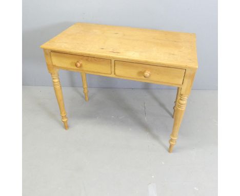 A modern pine dressing / writing table, with two frieze drawers and raised on turned legs. 91x77x50cm. 