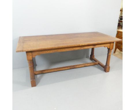 An early 20th century oak plank top dining table, raised on turned legs with H-shaped stretcher. 199x77x91cm.Good used condit