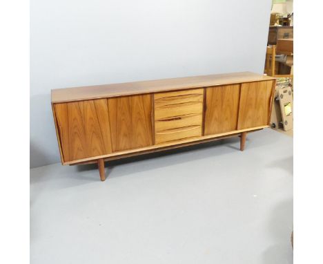 DYRLUND - A mid-century Danish teak sideboard, in the manner of Arne Vodder, with maker's label. 220x79x47cm.Good condition, 
