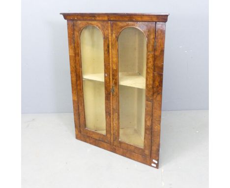 A Victorian burr walnut veneered hanging corner cupboard, with two glazed doors and single shelf. 65x80x32cm. 
