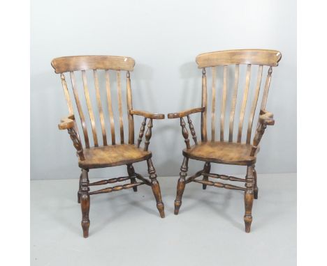 A pair of oak Windsor kitchen armchairs.Generally good condition, some glue residue beneath seat to tops of legs, some light 