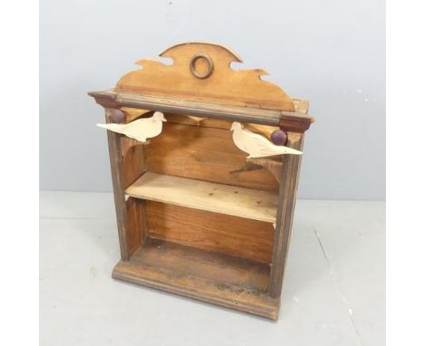 A hand-made hanging shelf of mixed timbers, with applied carved dove decoration. 56x70x23cm. 