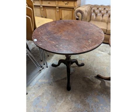 An antique mahogany circular tilt-top occasional table, with birdcage movement and raised on a turned central column with tri