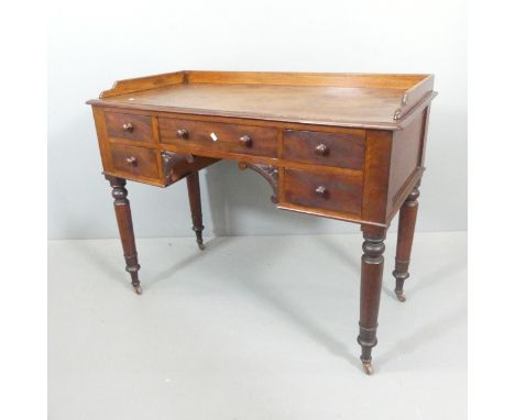 A Victorian mahogany writing table, with oak top, raised back and sides and five drawers. Overall 107x84x53cm, kneehole 37x61