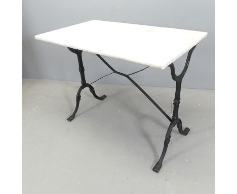 A rectangular dry marble-topped garden table on cast iron frame. 89x71x53cm. 