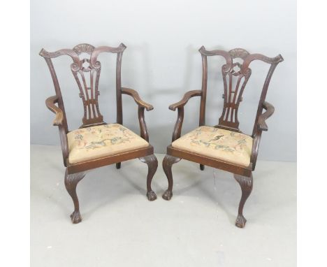 A pair of 19th century Chippendale style open arm chairs, with tapestry upholstered drop-in seats, and raised on cabriole leg