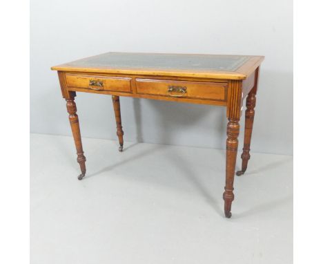 A Victorian oak and mahogany writing table, with two frieze drawers, turned legs and tooled and embossed green leather skiver