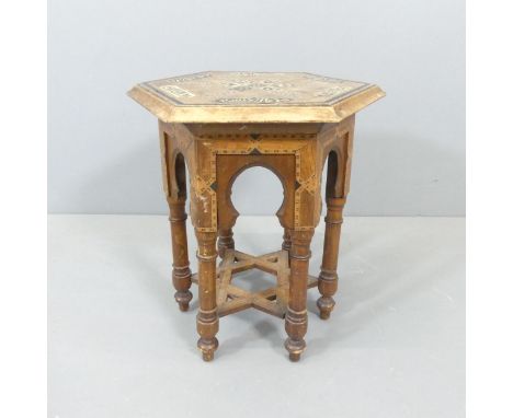 A Syrian hardwood hexagonal occasional table, with inlaid mother-of-pearl, bone and specimen decoration. 44x48x38cm.