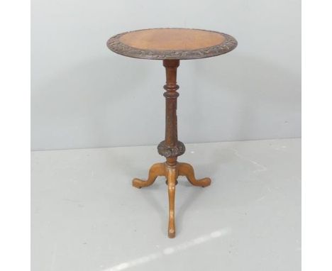 A Victorian mahogany and walnut circular topped occasional table, with carved decoration and tripod base. 43x72cm. 