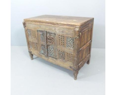 An early 19th century carved Indian hardwood Damchiya dowry chest with later top and shelf, with traces or original paint. 11