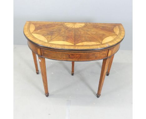A Georgian crossbanded rosewood and mahogany demi-lune fold-over card table, with inlaid satinwood and ebonised decoration. 1
