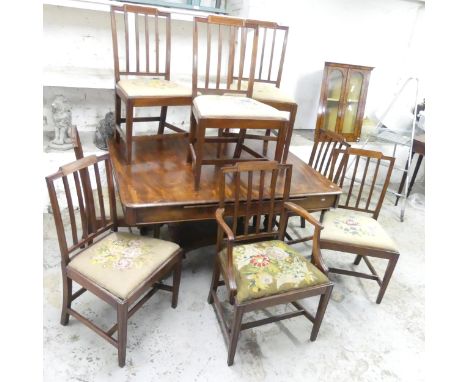 A William IV mahogany draw-leaf dining table, raised on platform base with sabre legs, 136x70x114cm (opening to 212cm), and a