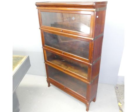 GLOBE-WERNICKE - An early 20th century mahogany four shelf sectional stacking bookcase, with maker's labels. Overall 87x141x2