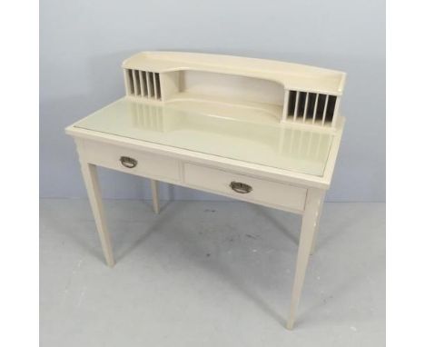 A painted pine writing table, with raised back. two drawers and raised on square tapered legs. 102x100x55cm. 