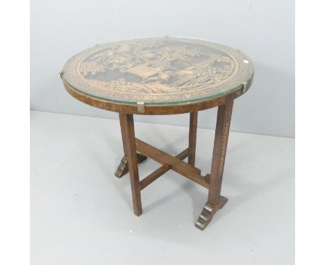 A Chinese hardwood tilt-top occasional table, with carved decoration and folding base. 61x62cm. 