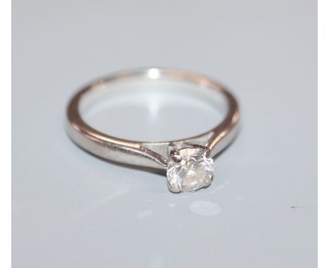 A modern 18ct white gold and solitaire diamond ring, the stone measuring 4.8mm. size K.