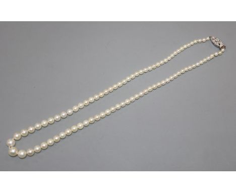 A single strand graduated cultured pearl necklace with diamond set white metal clasp, 40cm.
