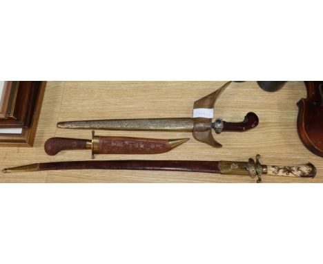 An 18th century and later hunting hanger, a 19th century Kris and an Indian dagger