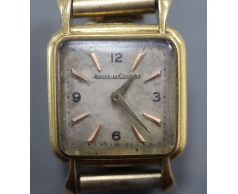A lady's 750 yellow metal Jaeger le Coultre manual wind wristwatch(a.f.), on associated rolled gold bracelet.