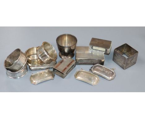 Four assorted silver match sleeves, five assorted silver napkin rings, three silver modern wine labels and an egg cup