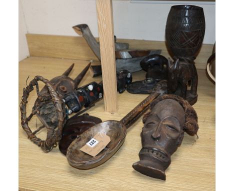 A quantity of African carvings, including a ladle and masks