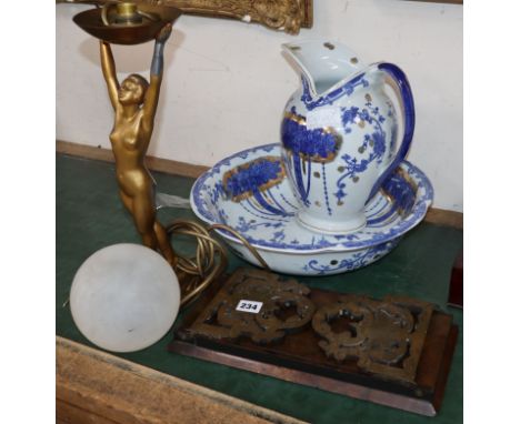 A brass and walnut book slide, An Art Deco lady lamp and blue and white jug and basin set.