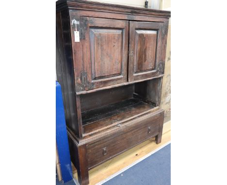 A 18th century Scottish oak Aumbry enclosed by a pair of panelled doors over an open shelf and drawer W.110cm