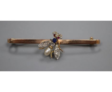 An early 20th century 9ct, diamond, sapphire, baroque pearl and ruby set 'fly' bar brooch, 59mm.